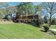 Exterior view showcasing a home with mature trees and lush lawn at 651 25Th Nw Ave, Hickory, NC 28601
