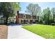 Charming brick home with manicured lawn, mature trees and a covered boat storage area at 651 25Th Nw Ave, Hickory, NC 28601