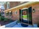 Detailed view of brick home's entrance, showing front door with wreath and tidy landscaping at 651 25Th Nw Ave, Hickory, NC 28601