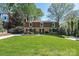 Charming front exterior with lush lawn, mature landscaping, and a long driveway at 651 25Th Nw Ave, Hickory, NC 28601