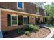 Close up of brick home with manicured landscaping, black shutters, and inviting front door at 651 25Th Nw Ave, Hickory, NC 28601