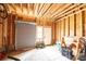 Interior of wooden framed garage with roll up door and shelving at 651 25Th Nw Ave, Hickory, NC 28601