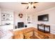 Cozy living room featuring a brick fireplace, built-in shelves, ceiling fan, and hardwood floors at 651 25Th Nw Ave, Hickory, NC 28601
