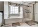 Modern bathroom with a tub, glass shower, and neutral color palette at 670 Belle Grove Dr, Clover, SC 29710