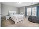 Bedroom with a white bed, windows, a large beanbag chair, and soft natural light at 670 Belle Grove Dr, Clover, SC 29710