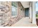 Inviting front porch featuring brick accents, white columns, and a cozy entrance at 670 Belle Grove Dr, Clover, SC 29710