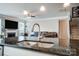 Kitchen featuring an island, faucet, and stainless steel appliances with an open floorplan at 670 Belle Grove Dr, Clover, SC 29710