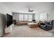 Large living room featuring a ceiling fan, many windows, a beige couch, and a black recliner at 670 Belle Grove Dr, Clover, SC 29710