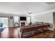 Spacious living room with hardwood floors, a fireplace, and a large sectional sofa at 670 Belle Grove Dr, Clover, SC 29710