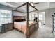 Spacious main bedroom with a four poster bed, ceiling fan, and sitting area at 670 Belle Grove Dr, Clover, SC 29710