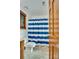 Bright bathroom with a toilet, vanity, and a blue and white striped shower curtain at 7831 Spinnaker Bay Dr # 106, Sherrills Ford, NC 28673