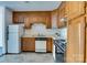 Well-lit kitchen with wooden cabinets, appliances, and ample counter space, perfect for culinary endeavors at 7831 Spinnaker Bay Dr # 106, Sherrills Ford, NC 28673