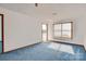 The living room includes blue carpet, lots of light, and exterior access at 7831 Spinnaker Bay Dr # 106, Sherrills Ford, NC 28673