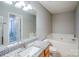 Bathroom features granite counters, wood cabinets, and soaking tub at 8545 Filbert Ln, Charlotte, NC 28215