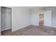Neutral bedroom featuring carpet, closet, and natural light at 8545 Filbert Ln, Charlotte, NC 28215