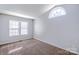 Neutral bedroom features carpet and window arch at 8545 Filbert Ln, Charlotte, NC 28215