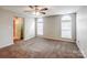 Spacious bedroom featuring a ceiling fan and carpeted floors and two large windows at 8545 Filbert Ln, Charlotte, NC 28215