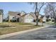 Residential street view with houses showing driveways, lawns, and suburban charm at 8545 Filbert Ln, Charlotte, NC 28215