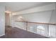 Spacious hallway with carpet floors, white railings, and arch window at 8545 Filbert Ln, Charlotte, NC 28215
