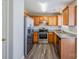 Stylish kitchen with stainless steel appliances, granite countertops, and wood cabinets at 8545 Filbert Ln, Charlotte, NC 28215