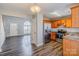 Open-concept kitchen features stainless appliances, wood cabinetry, and modern flooring at 8545 Filbert Ln, Charlotte, NC 28215