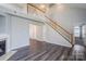Spacious living room features a staircase, fireplace, and modern flooring at 8545 Filbert Ln, Charlotte, NC 28215