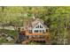 A picturesque aerial view shows multi-level decks, lush trees, and an attractively landscaped lot at 9004 Cebu Ct, Fort Mill, SC 29708