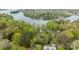 A beautiful aerial view of lush trees and a waterfront property with surrounding trees and landscaping at 9004 Cebu Ct, Fort Mill, SC 29708
