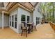 Spacious back deck with wooden furniture that's perfect for entertaining guests or relaxing outdoors at 9004 Cebu Ct, Fort Mill, SC 29708
