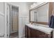 This bathroom features a wood vanity, a sink with a faucet, a mirror and a shower at 9004 Cebu Ct, Fort Mill, SC 29708
