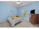 Cozy bedroom featuring blue walls, carpet flooring, and a ceiling fan at 9004 Cebu Ct, Fort Mill, SC 29708