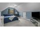 Comfortable bedroom with blue walls, carpet flooring, and a sloped ceiling at 9004 Cebu Ct, Fort Mill, SC 29708