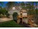Charming multi-level home featuring a two-car garage, upper and lower wooden decks, and professional landscaping at 9004 Cebu Ct, Fort Mill, SC 29708