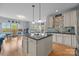 Open-concept kitchen with center island, hardwood floors and white cabinetry at 9004 Cebu Ct, Fort Mill, SC 29708