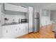 Efficient kitchenette with white cabinets, stainless steel appliances, and hardwood floors at 9004 Cebu Ct, Fort Mill, SC 29708