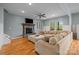 Spacious living room with hardwood floors, a stone fireplace, and comfortable sectional sofa at 9004 Cebu Ct, Fort Mill, SC 29708