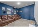 Cozy media room with a big blue wall and two large leather sofas to seat the entire Gathering at 9004 Cebu Ct, Fort Mill, SC 29708