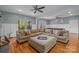 Expansive living room with hardwood floors, a plush sectional sofa, and an adjacent pool table at 9004 Cebu Ct, Fort Mill, SC 29708