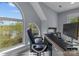 Bright home office featuring a large arched window with scenic views, and a modern desk setup at 9004 Cebu Ct, Fort Mill, SC 29708
