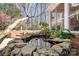 Backyard pond with beautiful stonework and lush plantings at 9417 Valley Rd, Charlotte, NC 28270