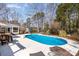 Backyard pool area with a clean patio, green surroundings, and outdoor seating at 9417 Valley Rd, Charlotte, NC 28270