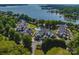 Stunning aerial view of lakefront property, lush trees, and communal pool; beautiful lake views at 101 N Cove Key Ln, Mooresville, NC 28117