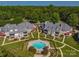 Aerial view featuring manicured grounds, a communal pool, and multi-story condominium buildings at 101 N Cove Key Ln, Mooresville, NC 28117
