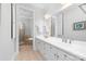 Bathroom featuring double vanities with white cabinets and a separate tub and shower area at 101 N Cove Key Ln, Mooresville, NC 28117