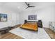 Spacious bedroom with a unique platform bed, modern ceiling fan and stylish decor at 101 N Cove Key Ln, Mooresville, NC 28117