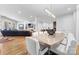 Open-concept design features a large dining table, hardwood floors, and seamless flow into the living room and kitchen at 101 N Cove Key Ln, Mooresville, NC 28117