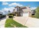 Charming home exterior with a two-car garage, stone accents, lush greenery and a concrete driveway at 101 N Cove Key Ln, Mooresville, NC 28117