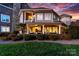 Inviting exterior view of a two-story home featuring a covered porch, stone accents, and manicured landscaping at 101 N Cove Key Ln, Mooresville, NC 28117