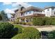 Beautiful two-story home featuring a covered patio, stone accents, and manicured landscaping at 101 N Cove Key Ln, Mooresville, NC 28117
