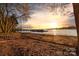 Picturesque waterfront view showcasing a dock, several boats, and a vibrant sunset at 101 N Cove Key Ln, Mooresville, NC 28117